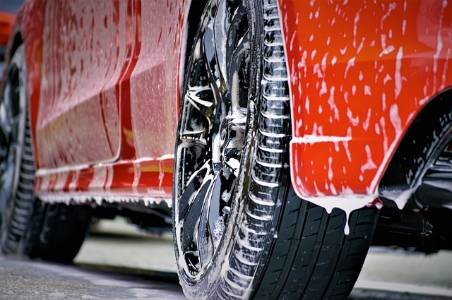 Red Car being washed at car wash